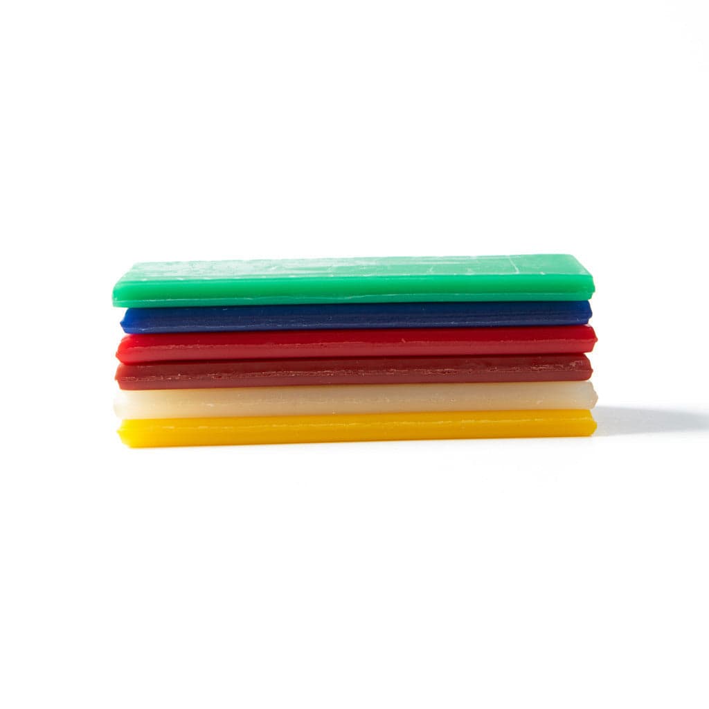 Open box containing six rectangular sheets of Stockmar modelling beeswax in assorted colours