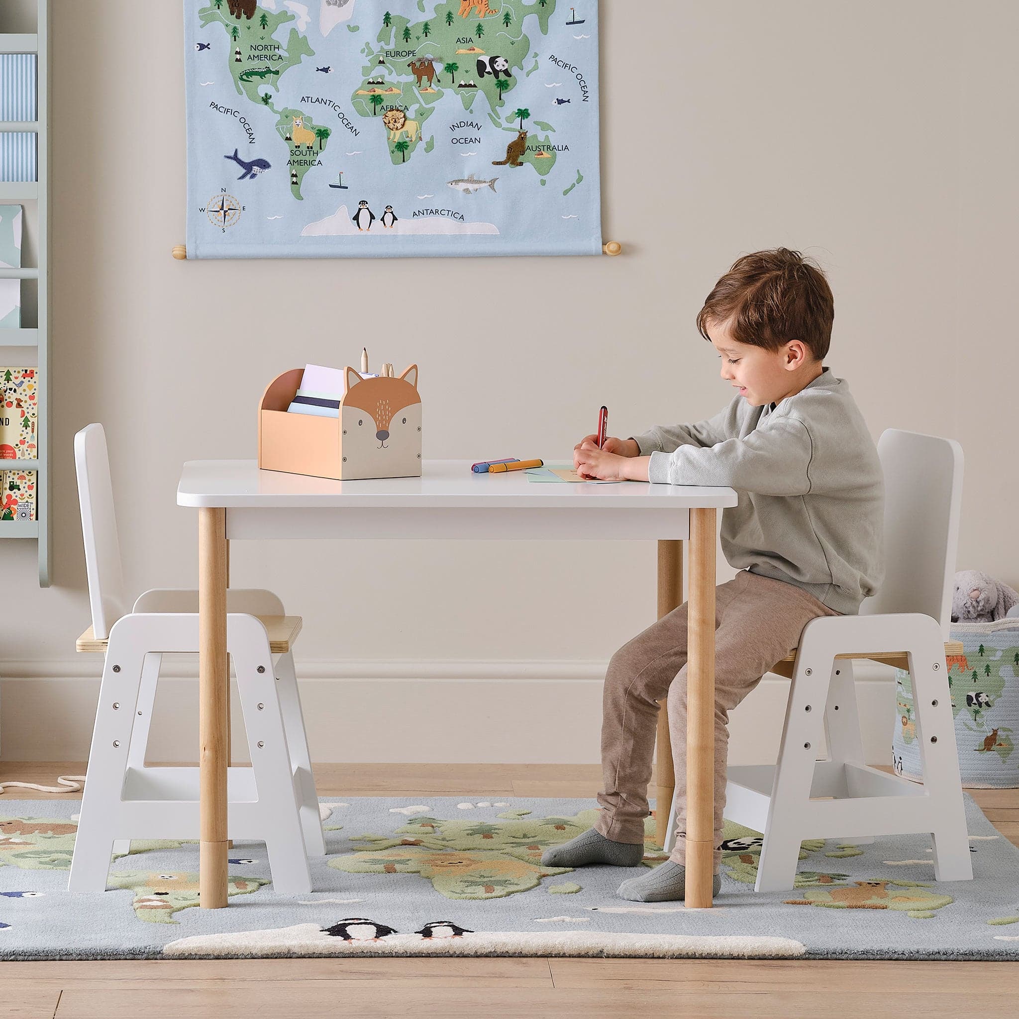 White rectangular Juniper children's table with pale wooden legs and matching leg extenders