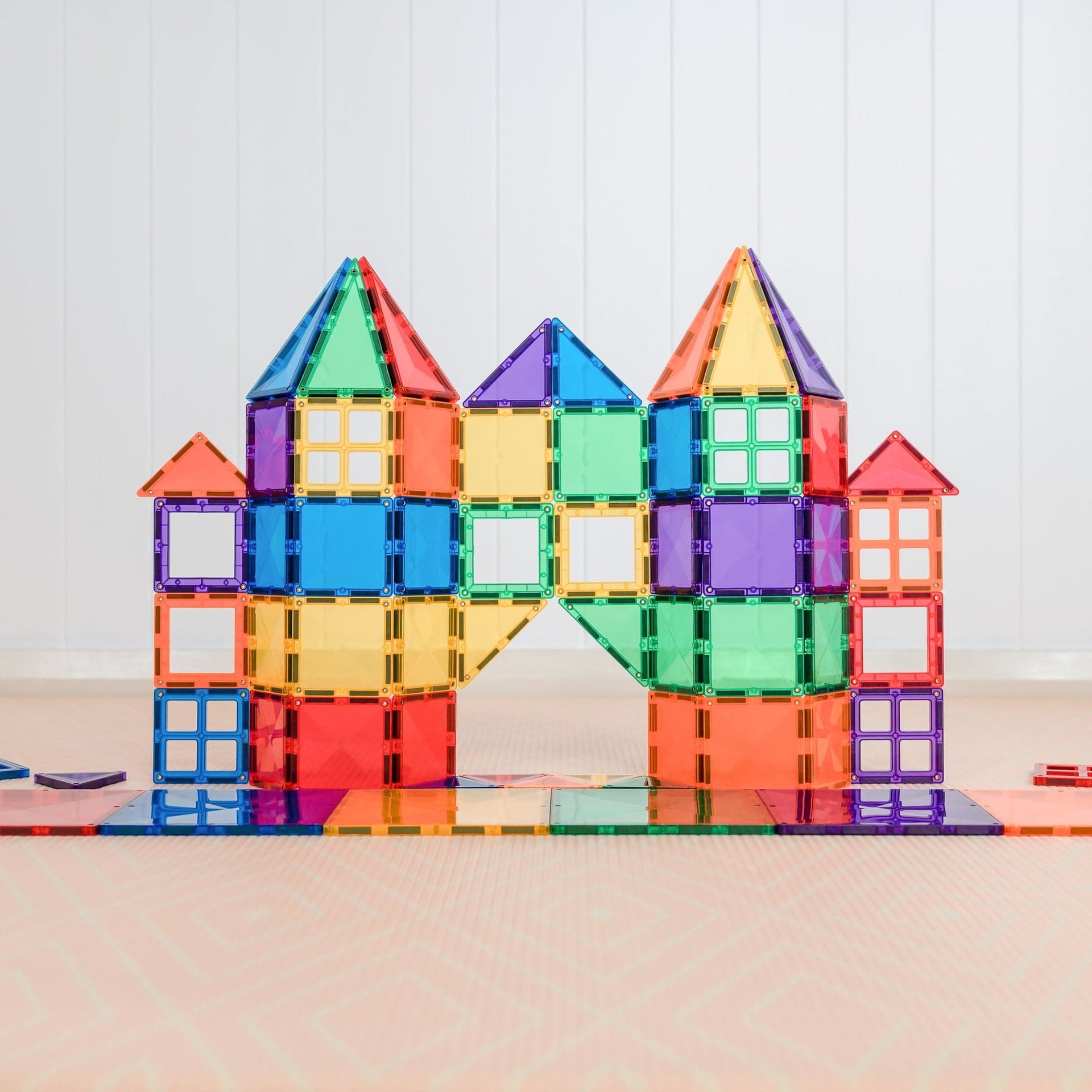 Box of CONNETIX Rainbow Starter Pack beside colourful magnetic-tile constructions